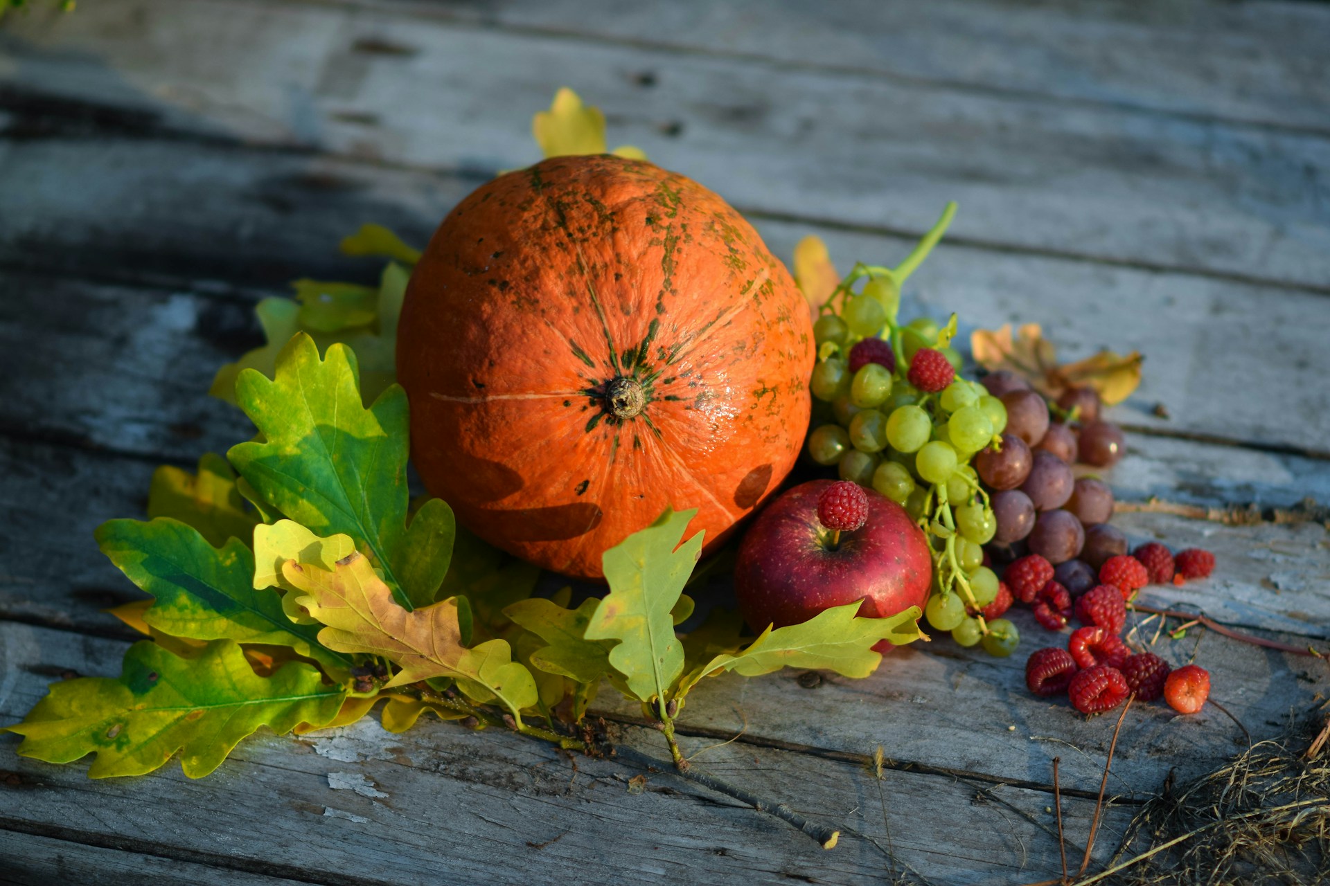 Pumpkin and autumnal fruits on a wooden table